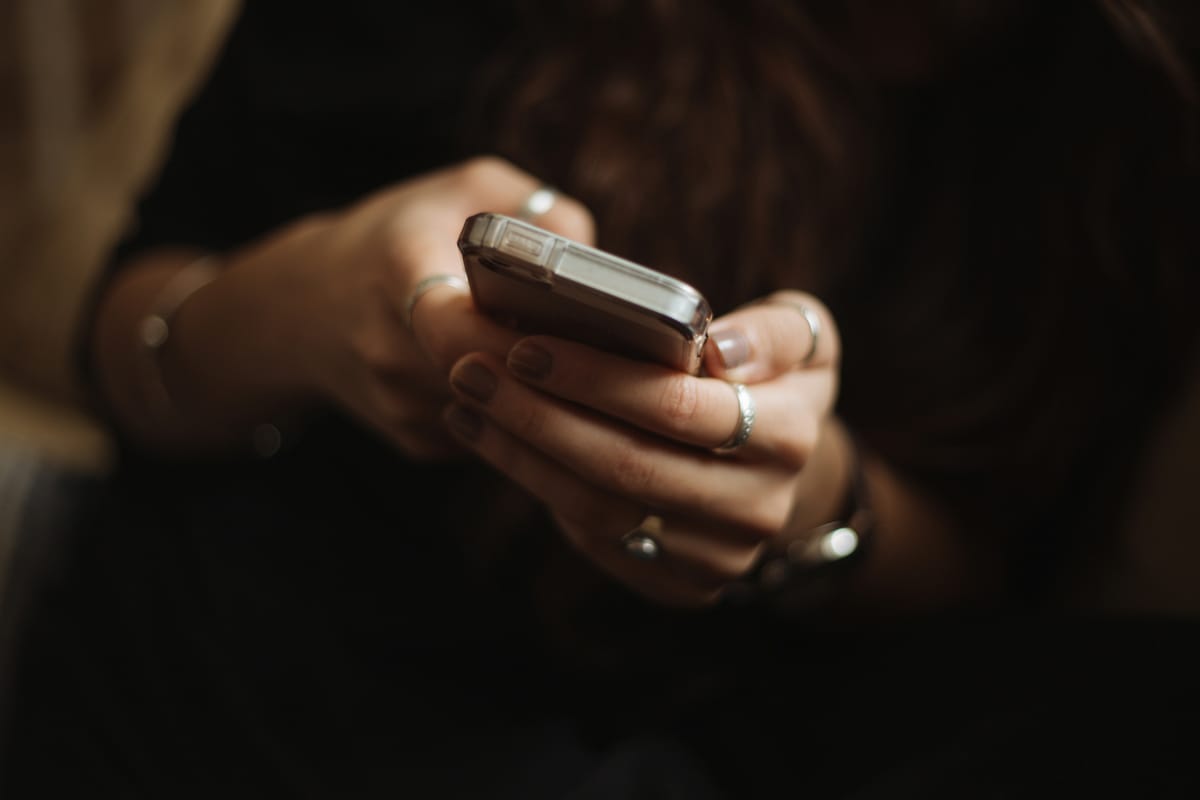 Person using smartphone to manage finances through a mobile banking app.