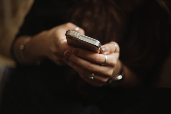 Person using smartphone to manage finances through a mobile banking app.